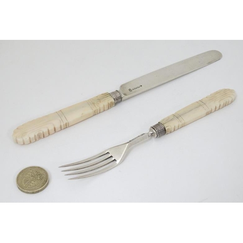 595 - A Wm IV silver fruit knife and fork with carved ivory handles. Hallmarked Sheffield 1832 maker J.B. ... 