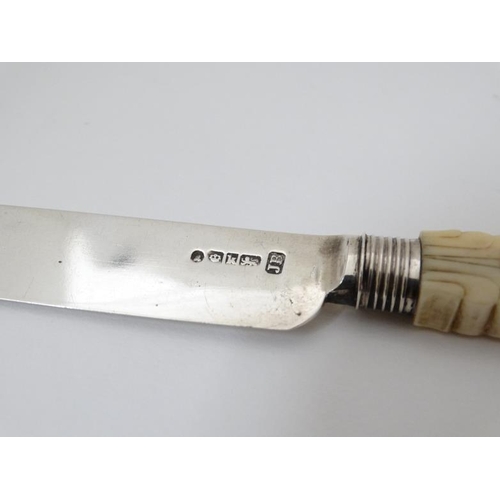 595 - A Wm IV silver fruit knife and fork with carved ivory handles. Hallmarked Sheffield 1832 maker J.B. ... 