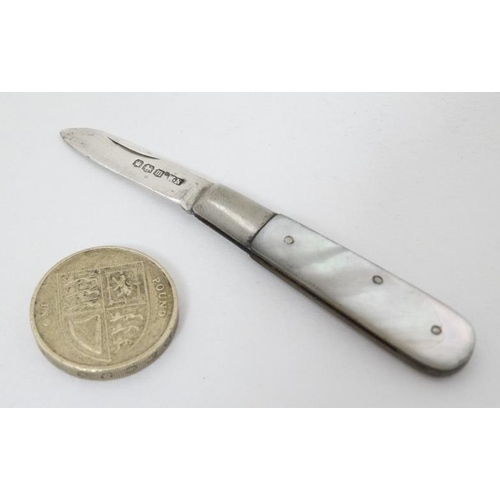 600 - A small mother of pearl folding fruit knife with mother of pearl handle and silver blade hallmarked ... 