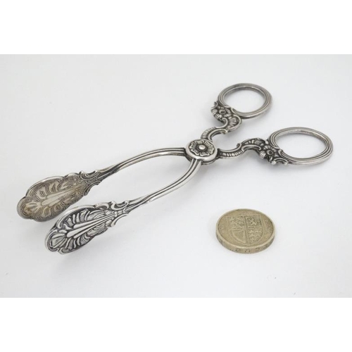 604 - Silver plate sugar nips with cast decoration 5 1/2'' long