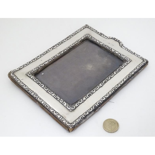 625 - A silver photograph frame hallmarked Chester 1906. The whole 7 3/4'' x 5 3/4''