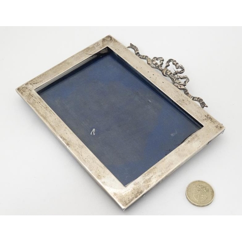 629 - A silver photograph frame with ribbon cresting to top. Hallmarked London 1905 maker J Batson & Son. ... 