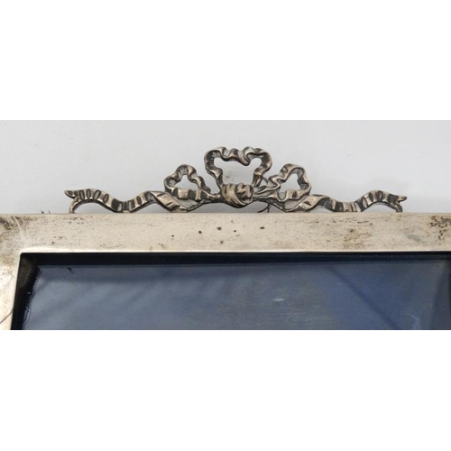 629 - A silver photograph frame with ribbon cresting to top. Hallmarked London 1905 maker J Batson & Son. ... 