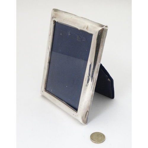 630 - A silver photograph frame . The whole 6 1/2'' high x 5'' wide