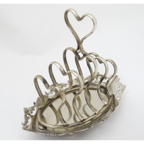 638 - Assorted silver plated wares comprising cruet frame / stand, toast rack, mother of pearl handled bre... 