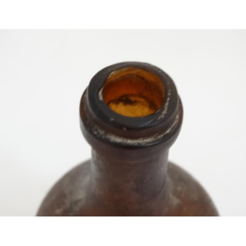 645 - An old onion shaped brown glass bottle of small proportion with slight iridescent lustre. Approx 5''... 