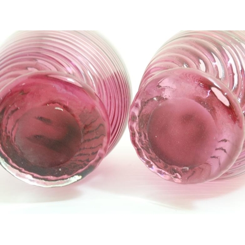 647 - A matched pair of cranberry glass vases with flared rims. The tallest 9'' high