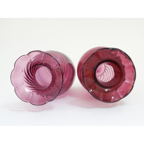 647 - A matched pair of cranberry glass vases with flared rims. The tallest 9'' high