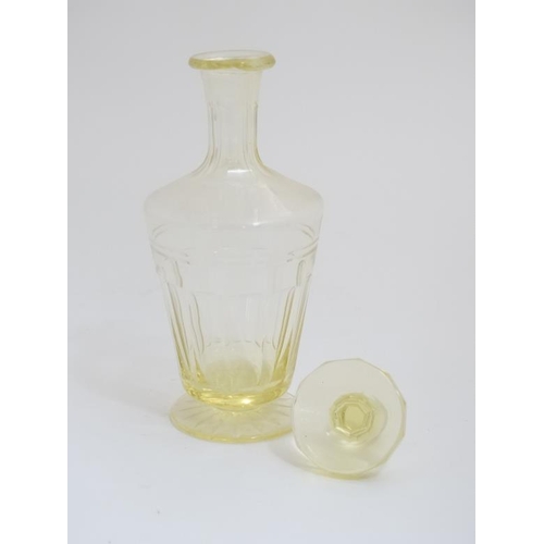 653 - A lemon yellow glass decanter and stopper. Approx 10 1/2'' high