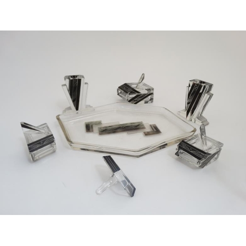 665 - An Art Deco dressing table set comprising tray with pair of candlesticks, ring tree, and various pot... 