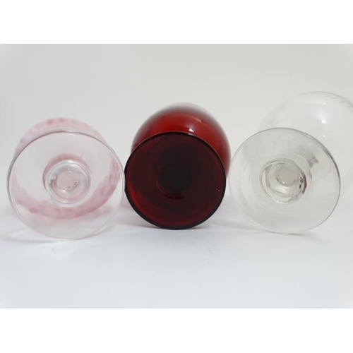 666 - Three large glass rummers, one ruby glass , one cranberry on a clear stem and foot and the other cle... 