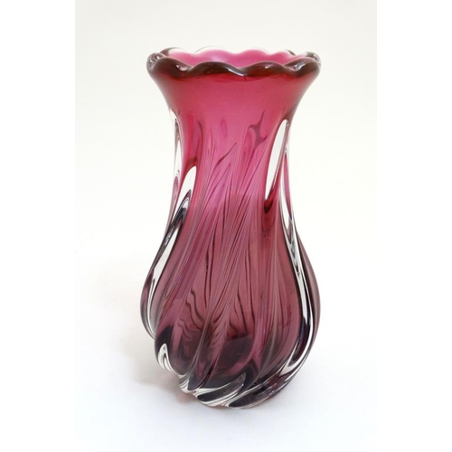 670 - A pink studio / Art Glass vase with swirled decoration 9 1/4'' high