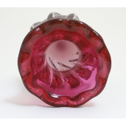 670 - A pink studio / Art Glass vase with swirled decoration 9 1/4'' high