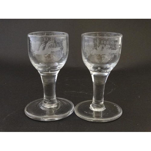 673 - Two 19thC cordial glasses each with engraved fruiting vine and bird in flight decoration. Approx 4''... 