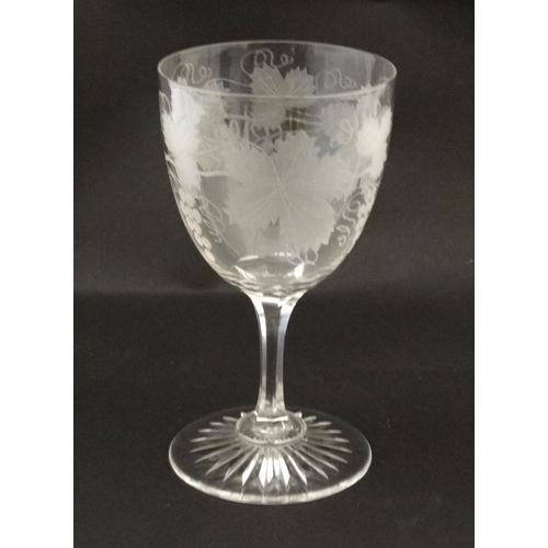 677 - A wine /  Barley Wine glass with etched fruiting vine decoration 7'' high