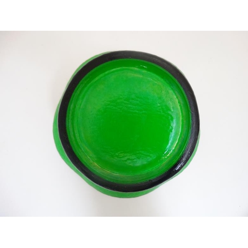 680 - A 20thC green glass bowl with flared rim and planished like textured finish to outer. Approx 11''wid... 