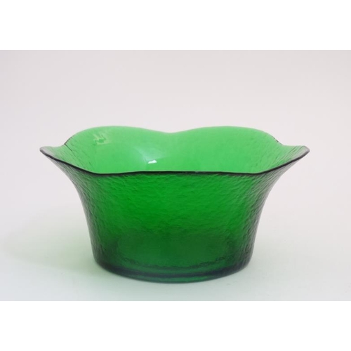 680 - A 20thC green glass bowl with flared rim and planished like textured finish to outer. Approx 11''wid... 