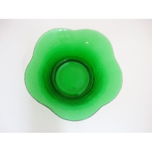 680 - A 20thC green glass bowl with flared rim and planished like textured finish to outer. Approx 11''wid... 