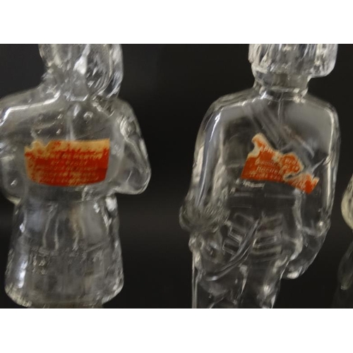 684 - 4 glass jars formed as various military figures, 3 having Bakelite screw bases. Approx 7'' high