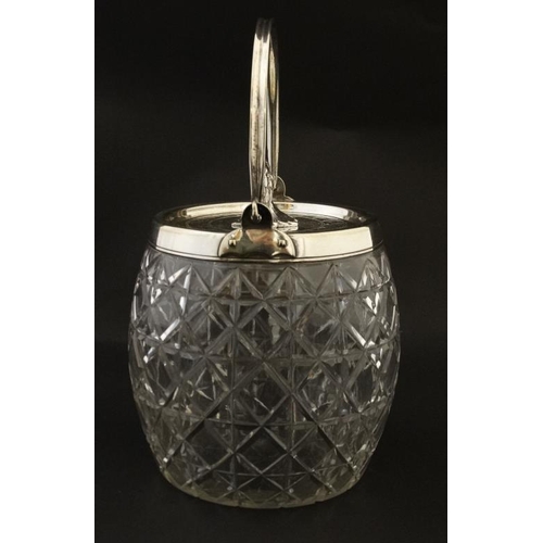 689 - A cut glass biscuit barrel with silver plated rim, swing handle and lid with stylised pheasant forme... 