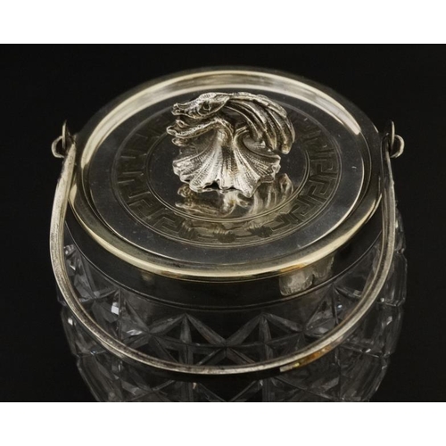 689 - A cut glass biscuit barrel with silver plated rim, swing handle and lid with stylised pheasant forme... 