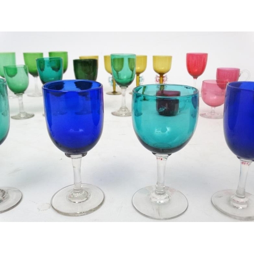 697 - Assorted glass ware - various coloured  drinking glasses to include  beakers, wine glasses etc ( app... 