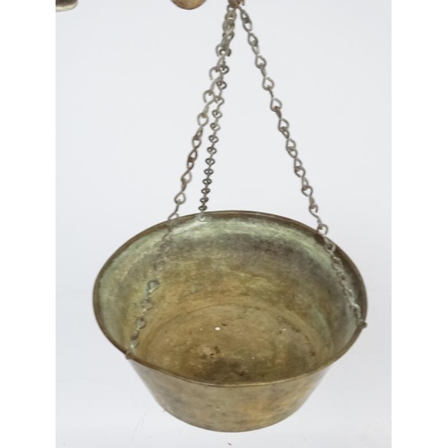 701 - Old brass hanging scales with large pan to one end and weight to other. The pan 14'' wide