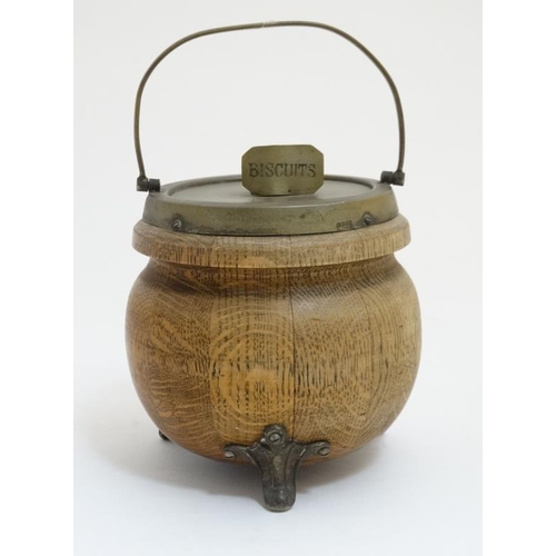 706 - A circa 1900 oak and silver plate three footed Biscuit Barrel , with swing over handle , named plaqu... 