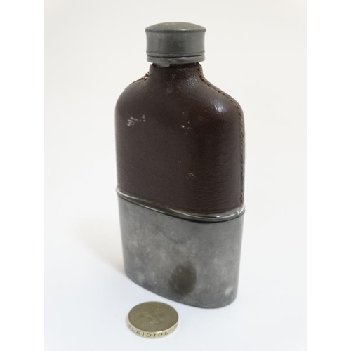 711 - A hip flask with half leather covering and beaker to base 5'' high