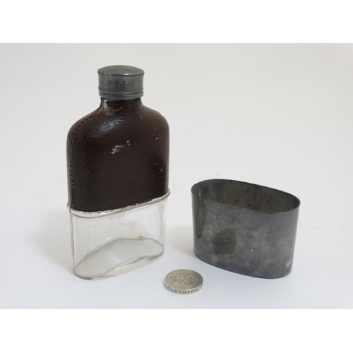 711 - A hip flask with half leather covering and beaker to base 5'' high