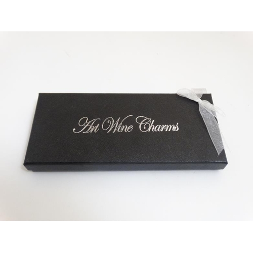 717 - A cased set of 'Art Wine Charms' for wine / cocktail glasses.