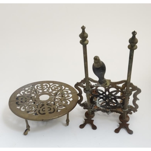 722 - An adjustable brass trivet together with another trivet / stand of circular form on four legs with s... 