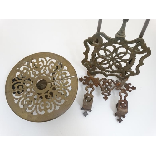 722 - An adjustable brass trivet together with another trivet / stand of circular form on four legs with s... 