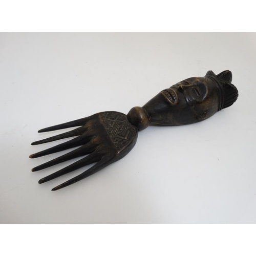 724 - Ethnographic Native Tribal : four assorted carved wooden African combs, the largest 11'' long