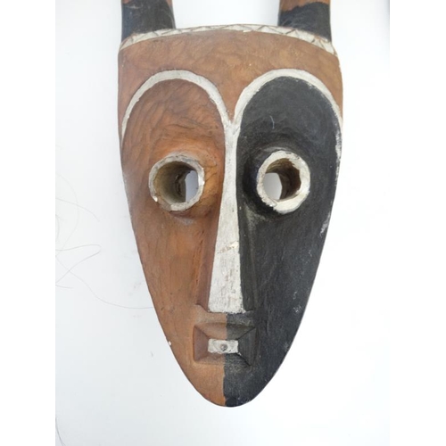 726 - Ethnographic Native Tribal : two assorted African wall masks , one with banded horns , the largest 2... 