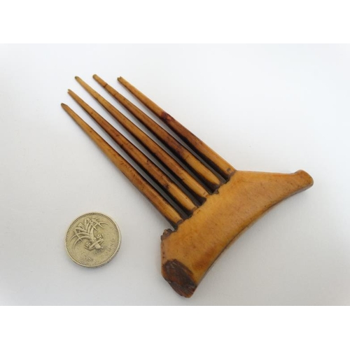 734 - Ethnographic Native Tribal: a 19thC patinated ivory hair piece comb , having 5 circular tapering tee... 