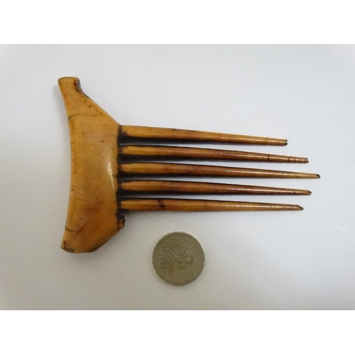 734 - Ethnographic Native Tribal: a 19thC patinated ivory hair piece comb , having 5 circular tapering tee... 