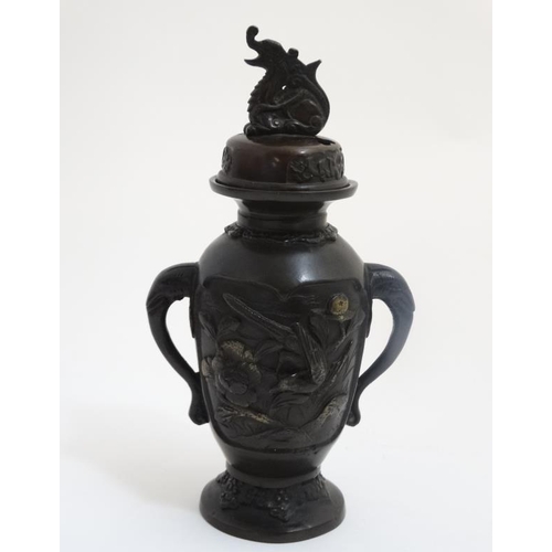 773 - A Bronze Japanese incense burner , c 1900 with two elephant head handles, a Kylin decorated top and ... 