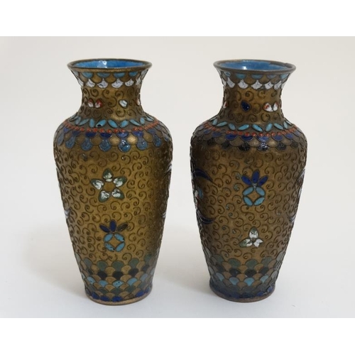 774 - A pair of Oriental Cloisonne decorated brass baluster shaped vases standing 4 1/2'' high