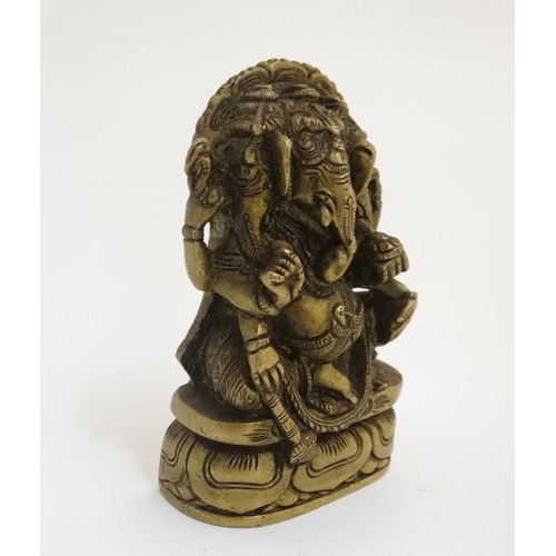 776 - A cast bronze figure of an Indian deity ( Gnesha ) seated upon a lotus flower base. 4 1/4'' high