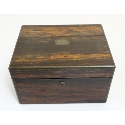 779 - A 19thC ladies Coromandel vanity box opening to reveal a fold down front with satinwood drawers and ... 