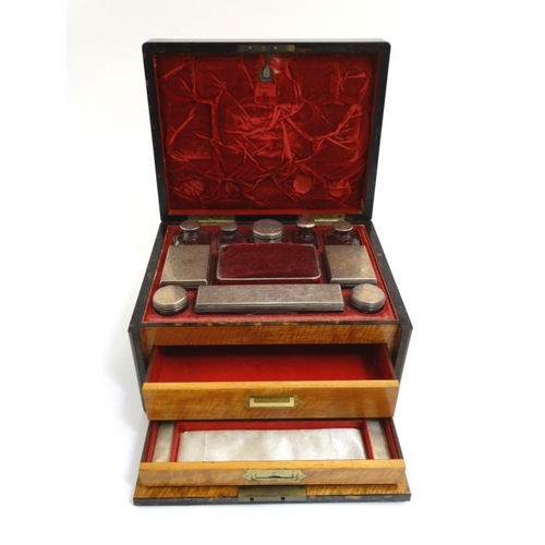 779 - A 19thC ladies Coromandel vanity box opening to reveal a fold down front with satinwood drawers and ... 