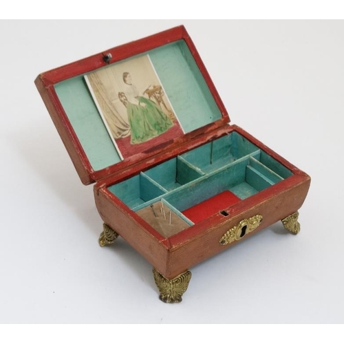 784 - A Regency gold tooled leather covered small sewing box with gilded legs, handle escutcheon etc pale ... 