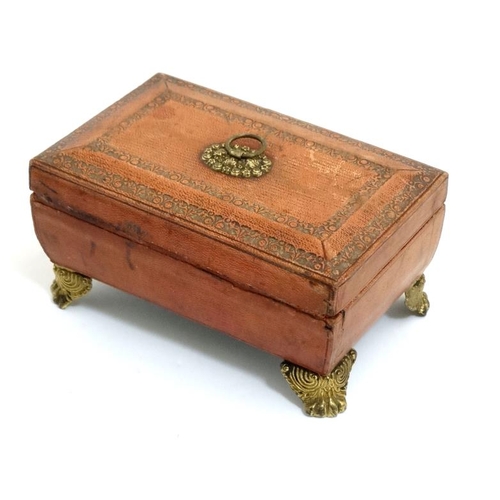 784 - A Regency gold tooled leather covered small sewing box with gilded legs, handle escutcheon etc pale ... 