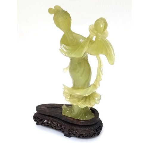 787 - A Chinese jade / jadeite figure and stand, 9 3/4'' high