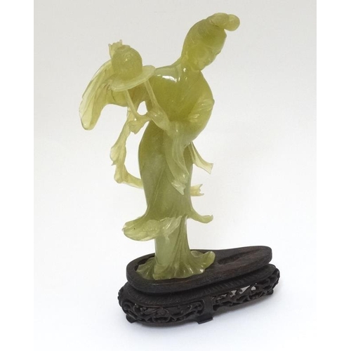 787 - A Chinese jade / jadeite figure and stand, 9 3/4'' high