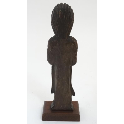 789 - A c.1900 carved wooden figure of a clergyman on a 20thC wooden stand. The whole standing 13 1/2'' hi... 