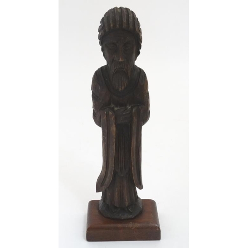 789 - A c.1900 carved wooden figure of a clergyman on a 20thC wooden stand. The whole standing 13 1/2'' hi... 