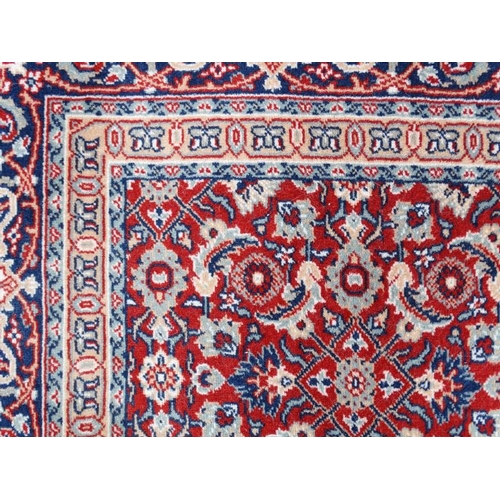 79 - Rug / Carpet :  a 20 thC Belgian Wilton rug with wine ground and 3 band borders,  100 x 65 1/2''