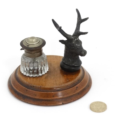 798 - A Desk top Standish the pen rest formed from a cast stag head  with glass ink bottle mounted upon a ... 